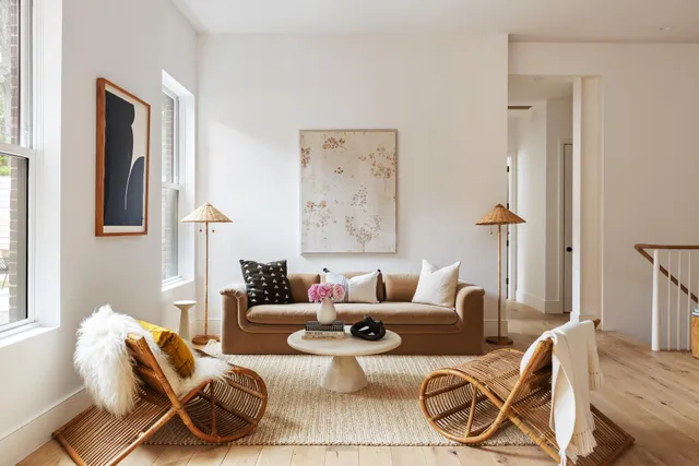 a living room with furniture and large windows