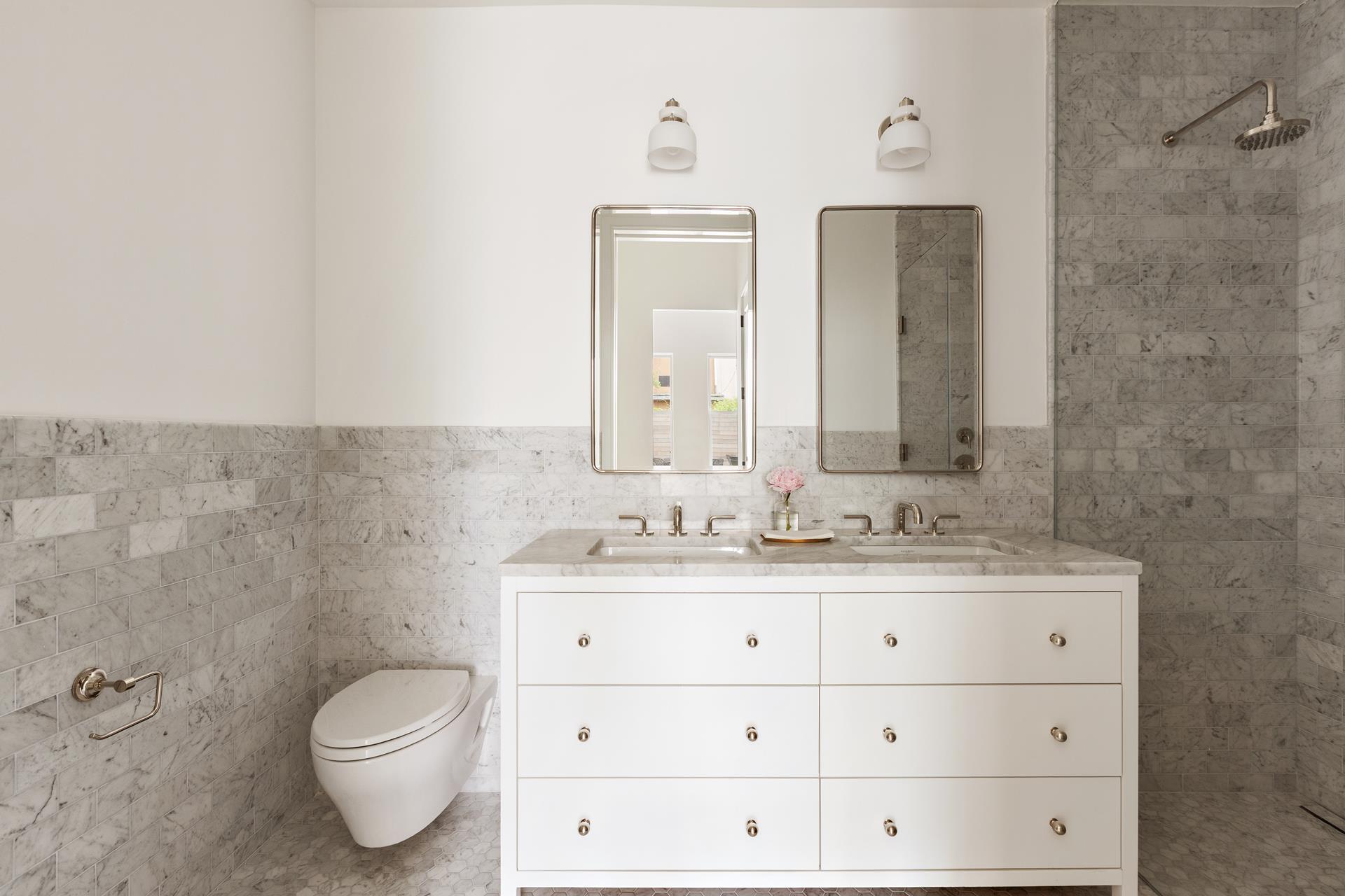 524 Halsey Street, Unit 105 Brooklyn, NY 11233 - Photo 6 of 15 a bathroom with a granite countertop toilet sink and mirror