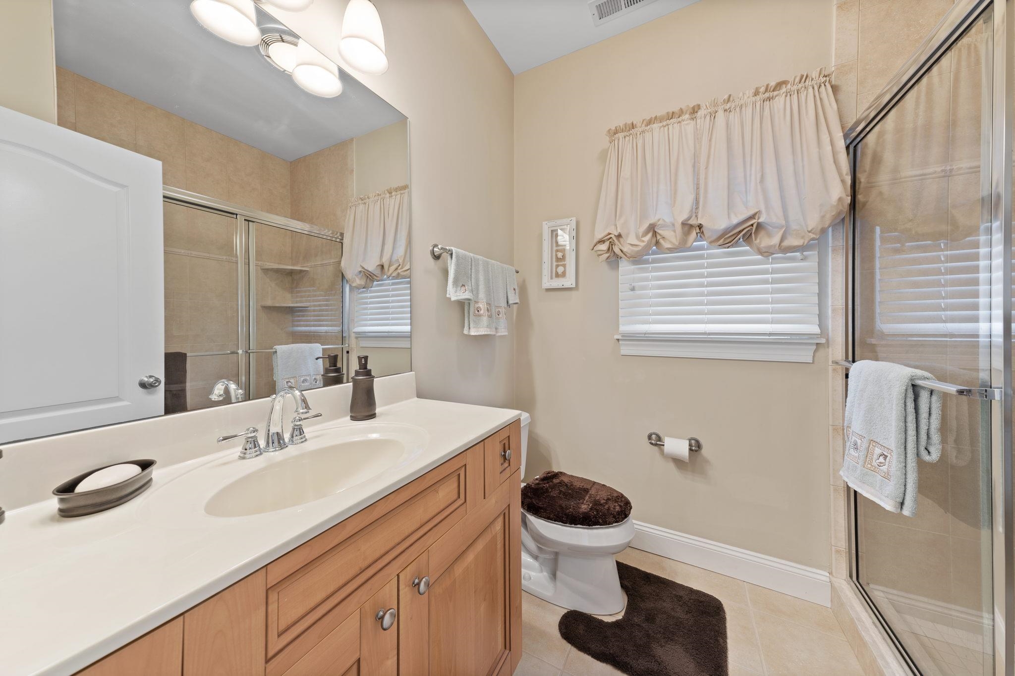 244 23rd Street Avalon, NJ 08202 - Photo 13 of 21 a bathroom with a sink toilet and shower