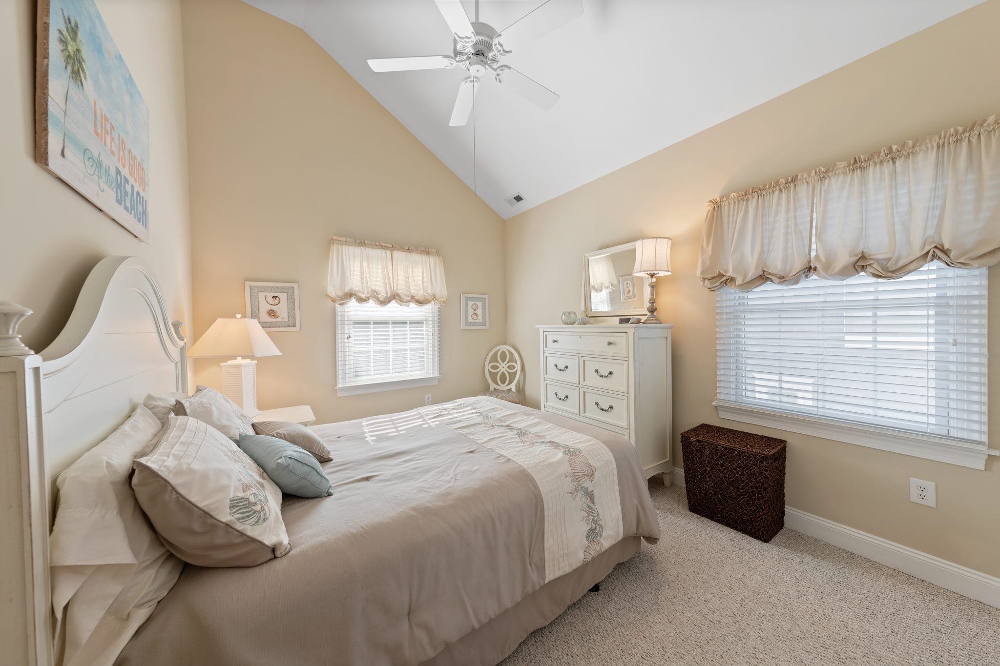 244 23rd Street Avalon, NJ 08202 - Photo 14 of 21 a bedroom with a bed a mirror and a flat tv screen on the dresser