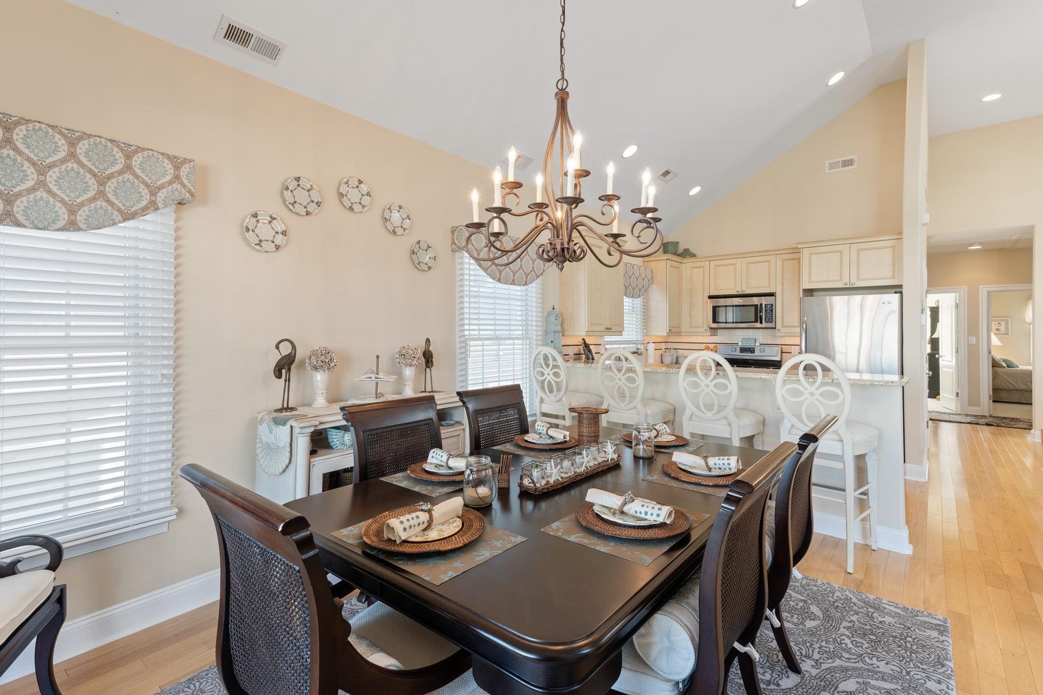 244 23rd Street Avalon, NJ 08202 - Photo 6 of 21 a dining room with furniture a chandelier and wooden floor