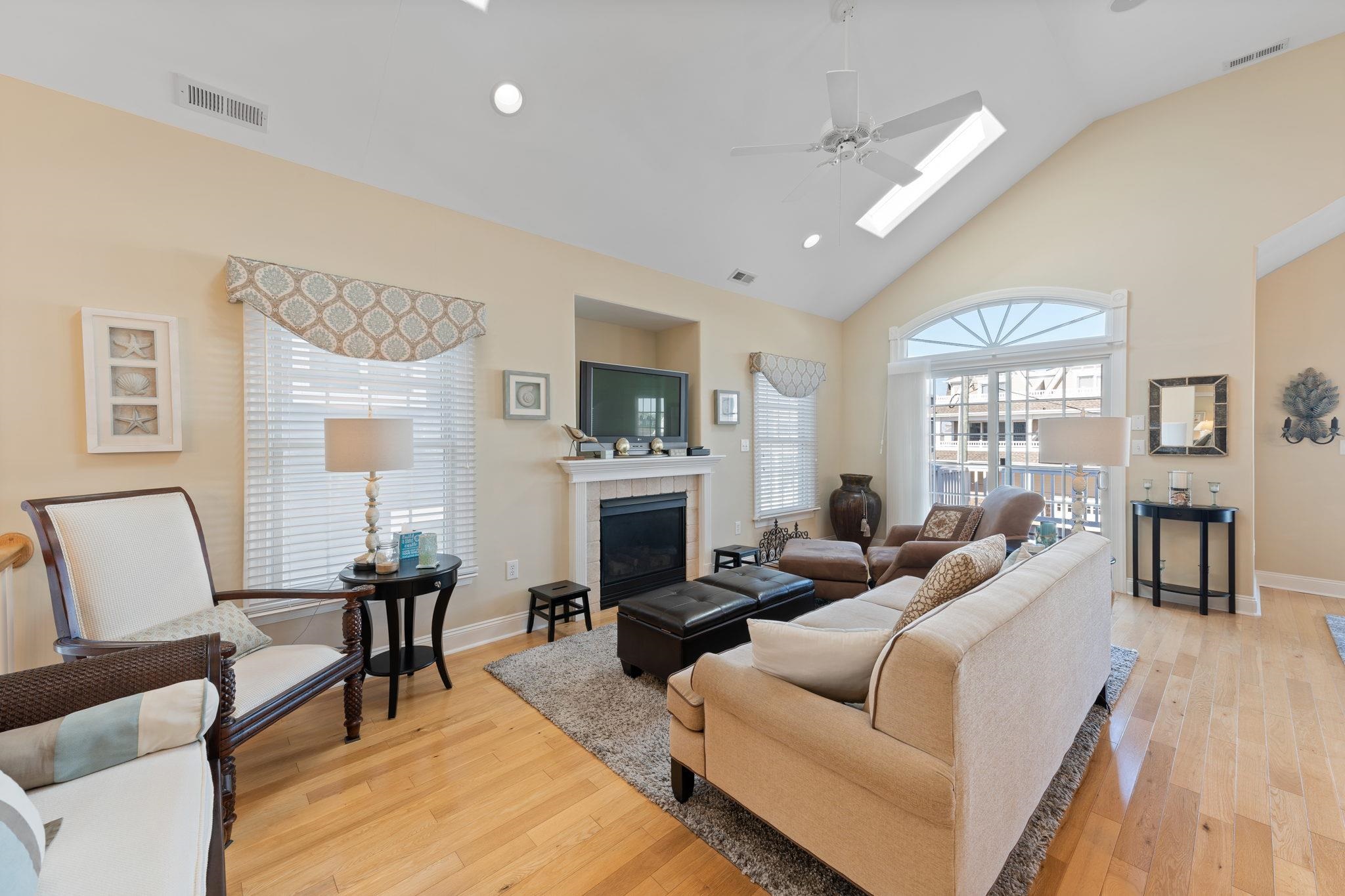 244 23rd Street Avalon, NJ 08202 - Photo 7 of 21 a living room with furniture a fireplace and a flat screen tv