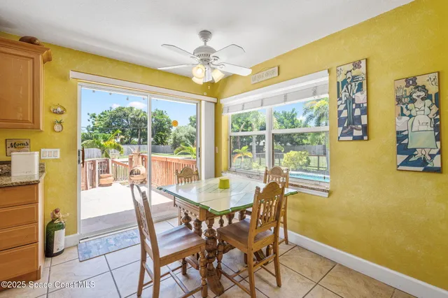 a dining room with furniture a chandelier and wooden floor