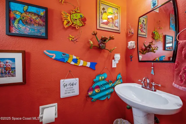 a bathroom with a sink mirror and vanity