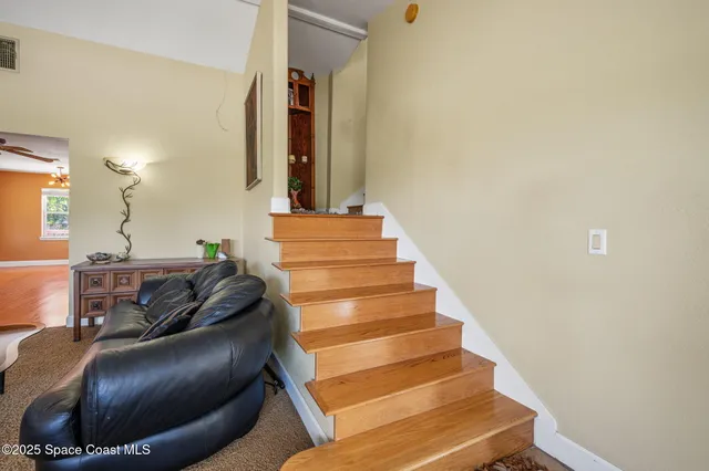 a spacious bedroom with a bed and wooden floor