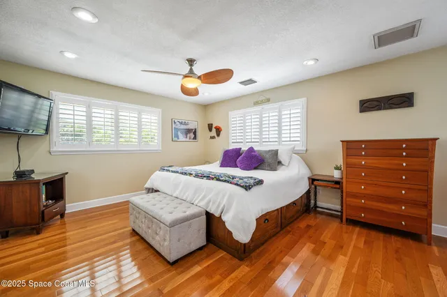 a bedroom with a bed and a large mirror