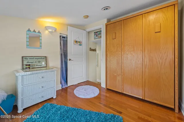 a bedroom with a bed and a dresser in it