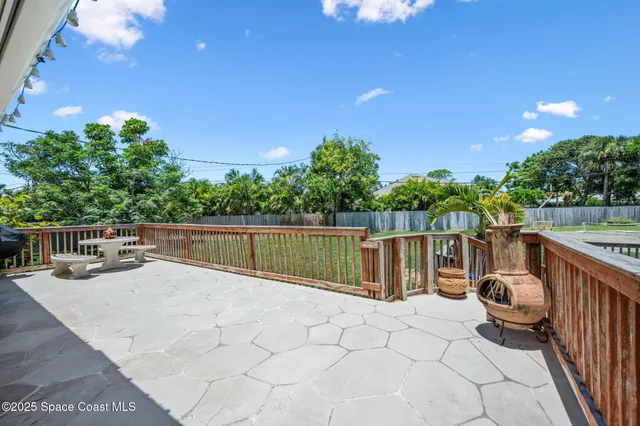 a view of a swimming pool with a patio and a garden