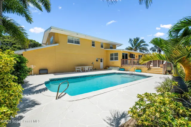 a swimming pool with outdoor seating and yard