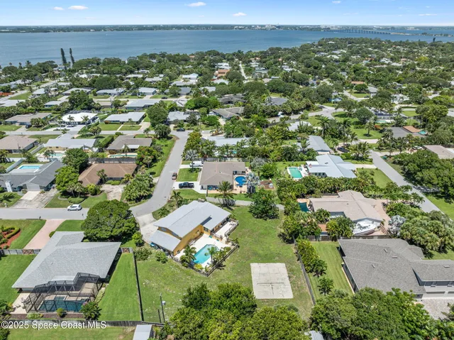 an aerial view of residential houses with outdoor space and street view
