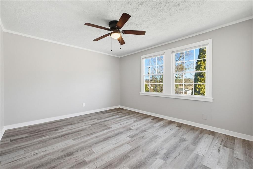 1789 Cahoon Street Southwest Atlanta, GA 30310 - Photo 11 of 12 a view of an empty room with wooden floor and a window