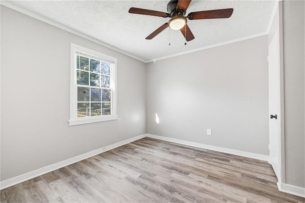 1789 Cahoon Street Southwest Atlanta, GA 30310 - Photo 13 of 15 an empty room with wooden floor closet and windows
