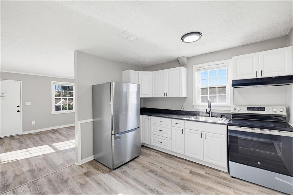 1789 Cahoon Street Southwest Atlanta, GA 30310 - Photo 2 of 12 a kitchen with granite countertop a refrigerator stove and sink