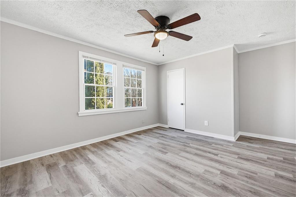 1789 Cahoon Street Southwest Atlanta, GA 30310 - Photo 8 of 12 an empty room with wooden floor and windows