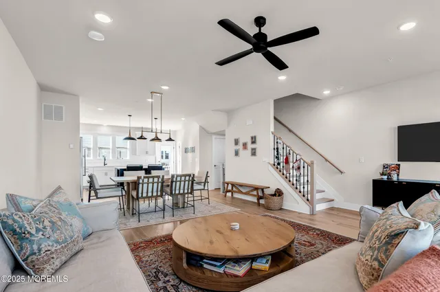 a living room with furniture and kitchen view