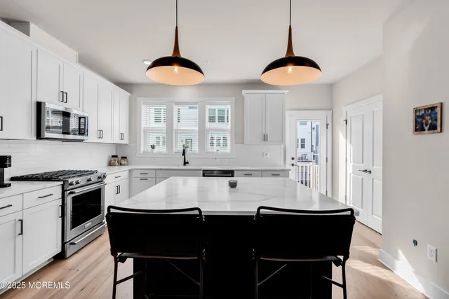 a kitchen with a sink stove and refrigerator
