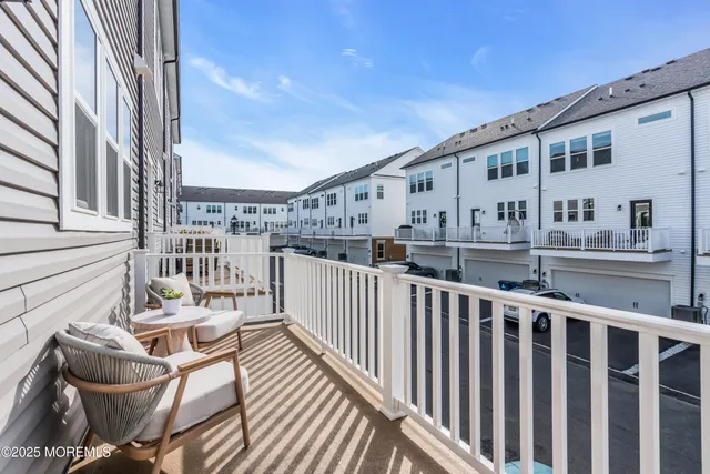 a kitchen with stainless steel appliances granite countertop a stove a sink dishwasher a stove a refrigerator a dining table and chairs with wooden floor