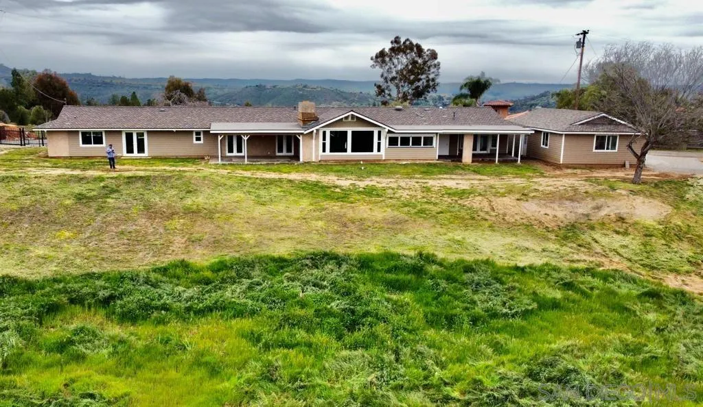 a front view of a residential houses with yard and lake view