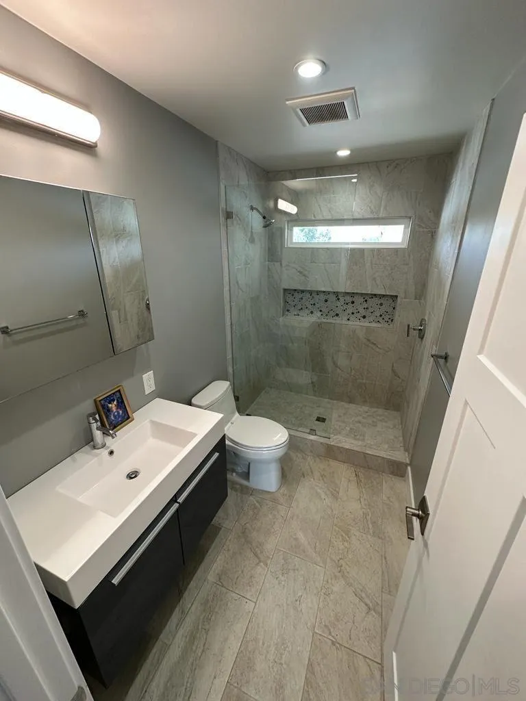 13822 Northcrest Lane Poway, CA 92064 - Photo 11 of 26 a bathroom with a sink a toilet a mirror and shower