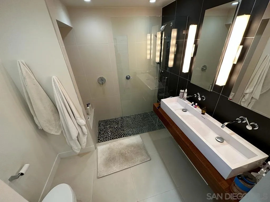 13822 Northcrest Lane Poway, CA 92064 - Photo 12 of 26 a bathroom with a sink a mirror and a toilet