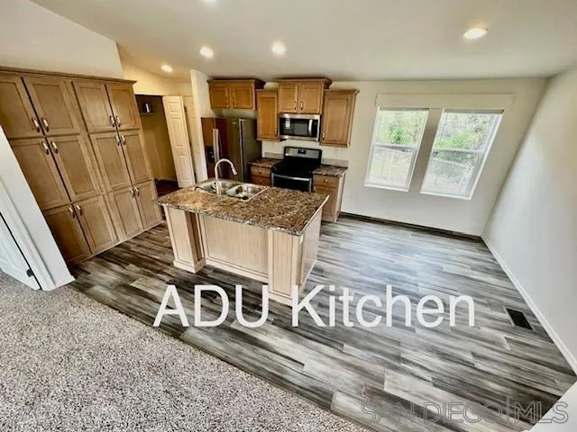 13822 Northcrest Lane Poway, CA 92064 - Photo 16 of 26 a view of a kitchen with stainless steel appliances granite countertop a stove a sink and a refrigerator