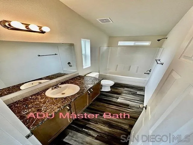 13822 Northcrest Lane Poway, CA 92064 - Photo 19 of 26 a bathroom with a sink mirror and toilet
