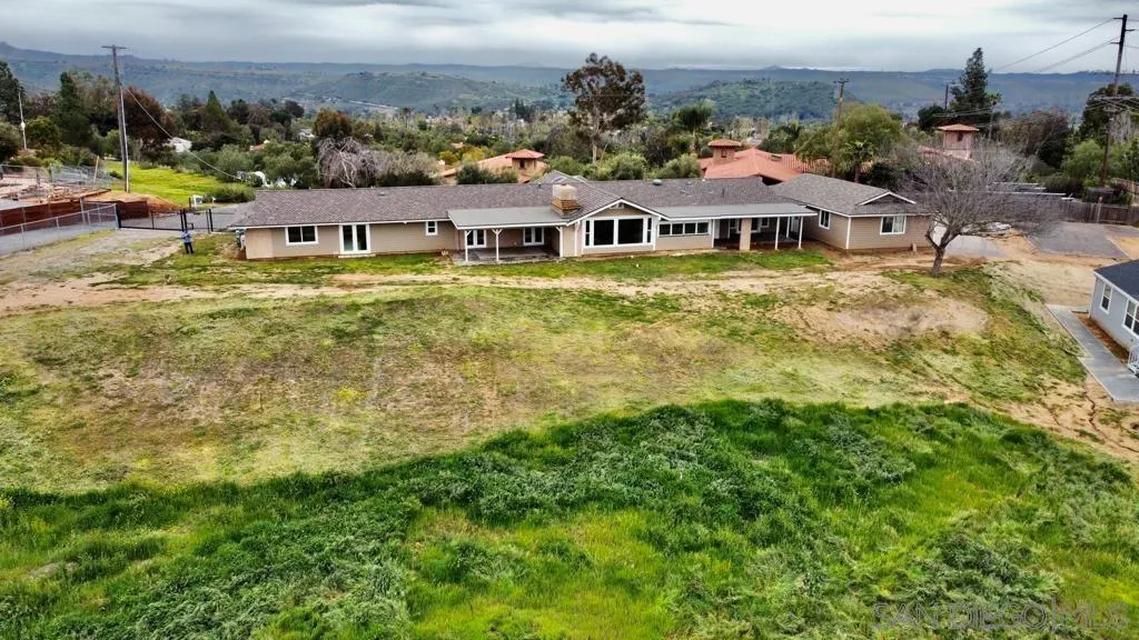 13822 Northcrest Lane Poway, CA 92064 - Photo 3 of 26 a aerial view of a house with swimming pool and lake view