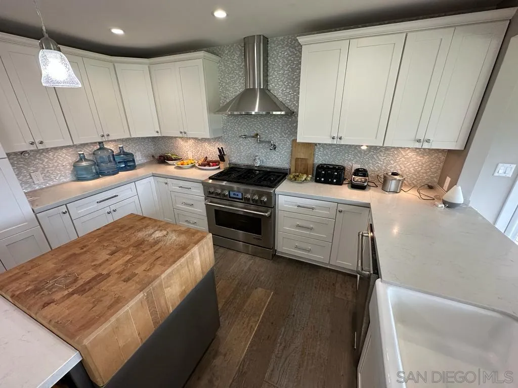 13822 Northcrest Lane Poway, CA 92064 - Photo 6 of 26 a kitchen with a stove a sink and a refrigerator