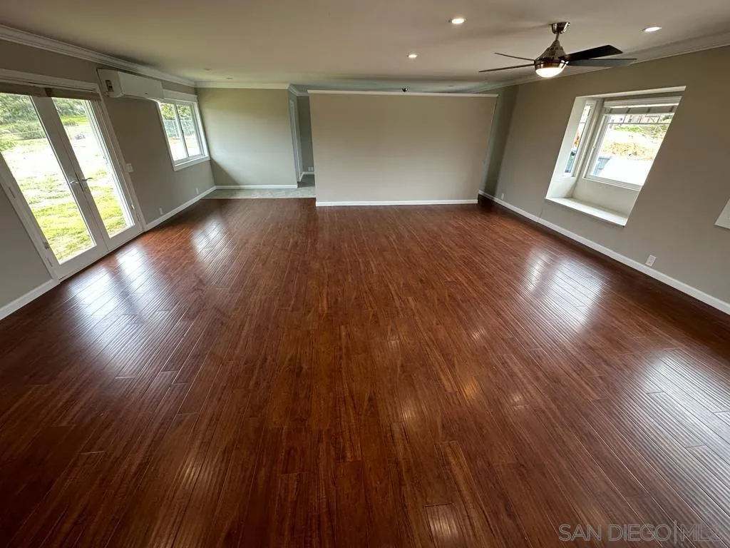 13822 Northcrest Lane Poway, CA 92064 - Photo 9 of 26 a view of an empty room with wooden floor and a window