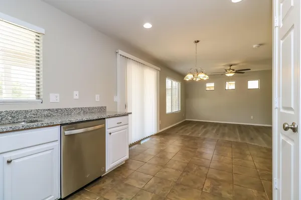a view of a kitchen with granite countertop a sink and dishwasher a granite counter top