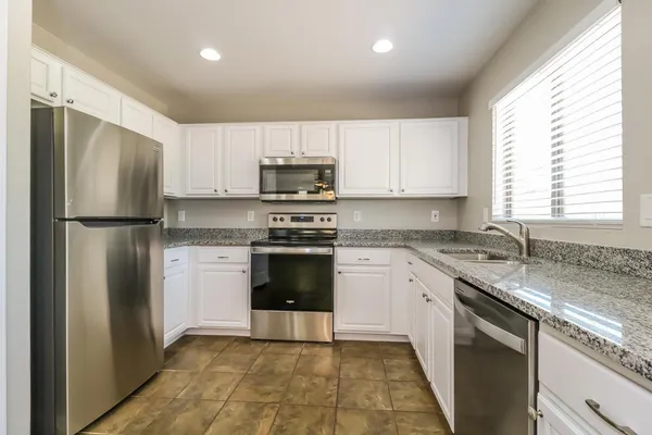 a kitchen with a sink stove and refrigerator