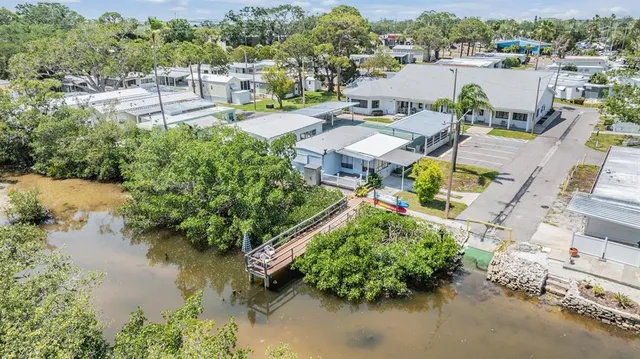 an aerial view of a house with outdoor space and lake view