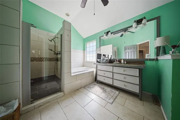 a bathroom with a mirror a sink and glass door