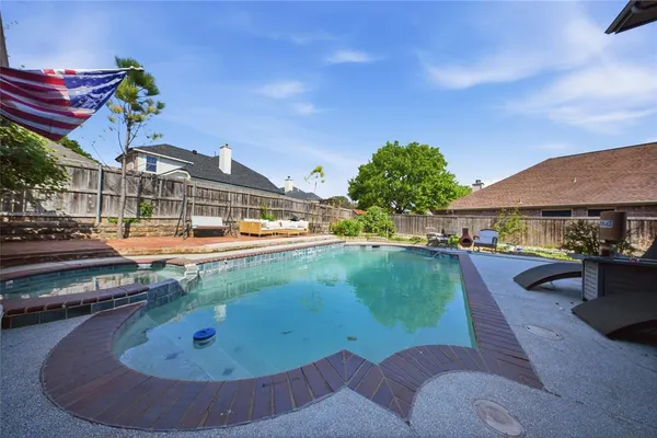 a view of a swimming pool with a patio