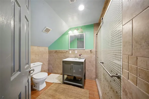 a bathroom with a toilet sink and mirror