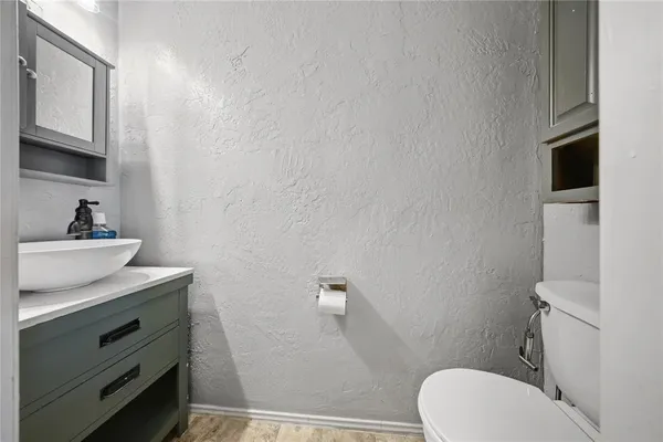 a bathroom with a sink a toilet and mirror