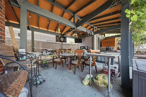 a view of a chairs with tables in a patio