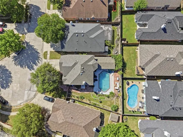 an aerial view of residential house with outdoor space and parking
