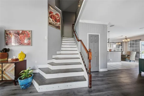 a view of entryway and hall with wooden floor