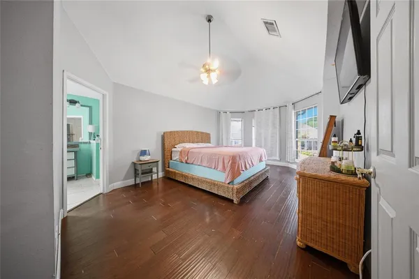 a bedroom with a bed and a chandelier