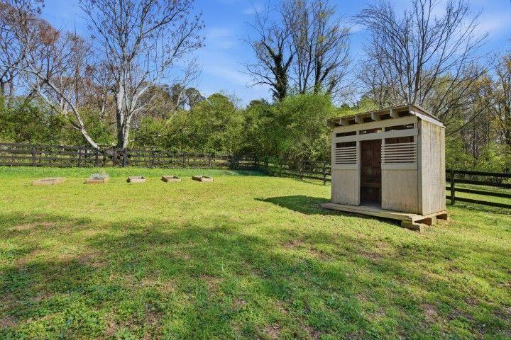2215 Roper Road Cumming, GA 30028 - Photo 11 of 24 a view of a backyard with large trees