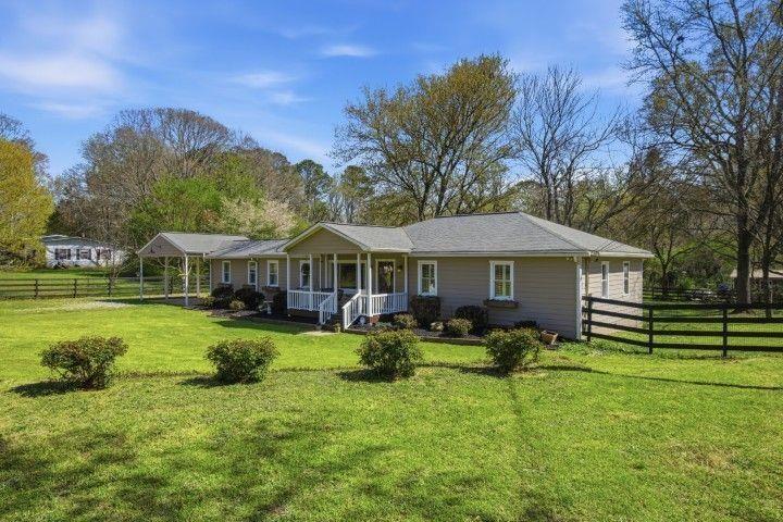 2215 Roper Road Cumming, GA 30028 - Photo 2 of 24 a front view of a house with garden