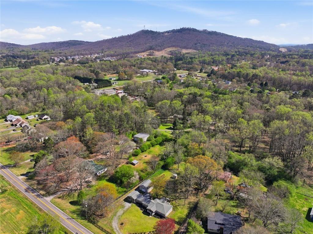 2215 Roper Road Cumming, GA 30028 - Photo 21 of 24 a view of a lush green hillside and houses