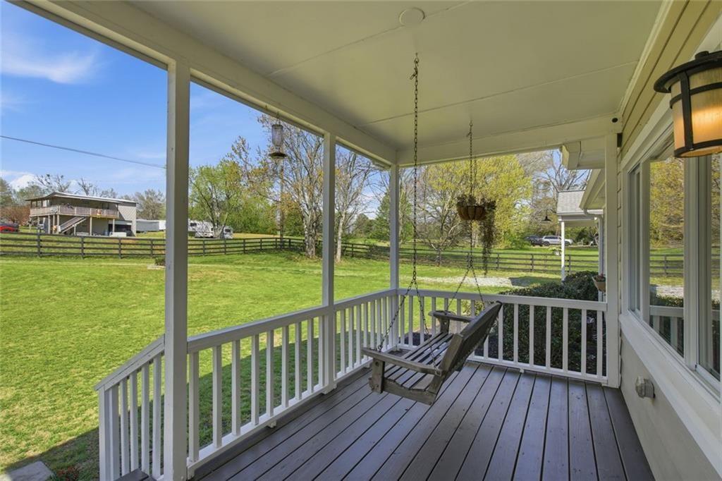 2215 Roper Road Cumming, GA 30028 - Photo 5 of 24 a view of a balcony with floor to ceiling windows with wooden floor
