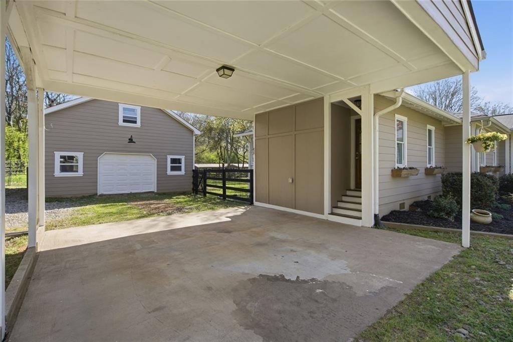 2215 Roper Road Cumming, GA 30028 - Photo 6 of 24 a view of a house with a yard and garage