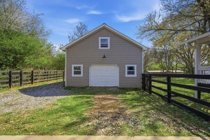 2215 Roper Road Cumming, GA 30028 - Photo 7 of 24 a view of a backyard with plants and large tree