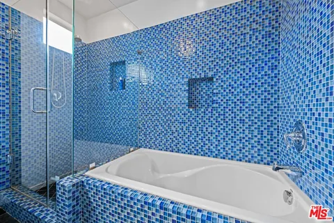 a bathroom with a bathtub and shower