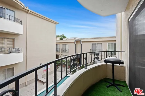 a view of balcony with furniture