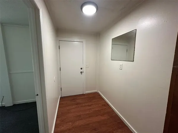 a view of hallway with wooden floor