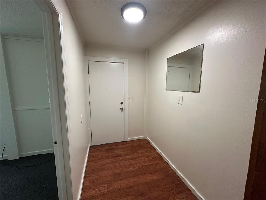 407 Poinsettia Road Daytona Beach, FL 32118 - Photo 3 of 10 a view of hallway with wooden floor